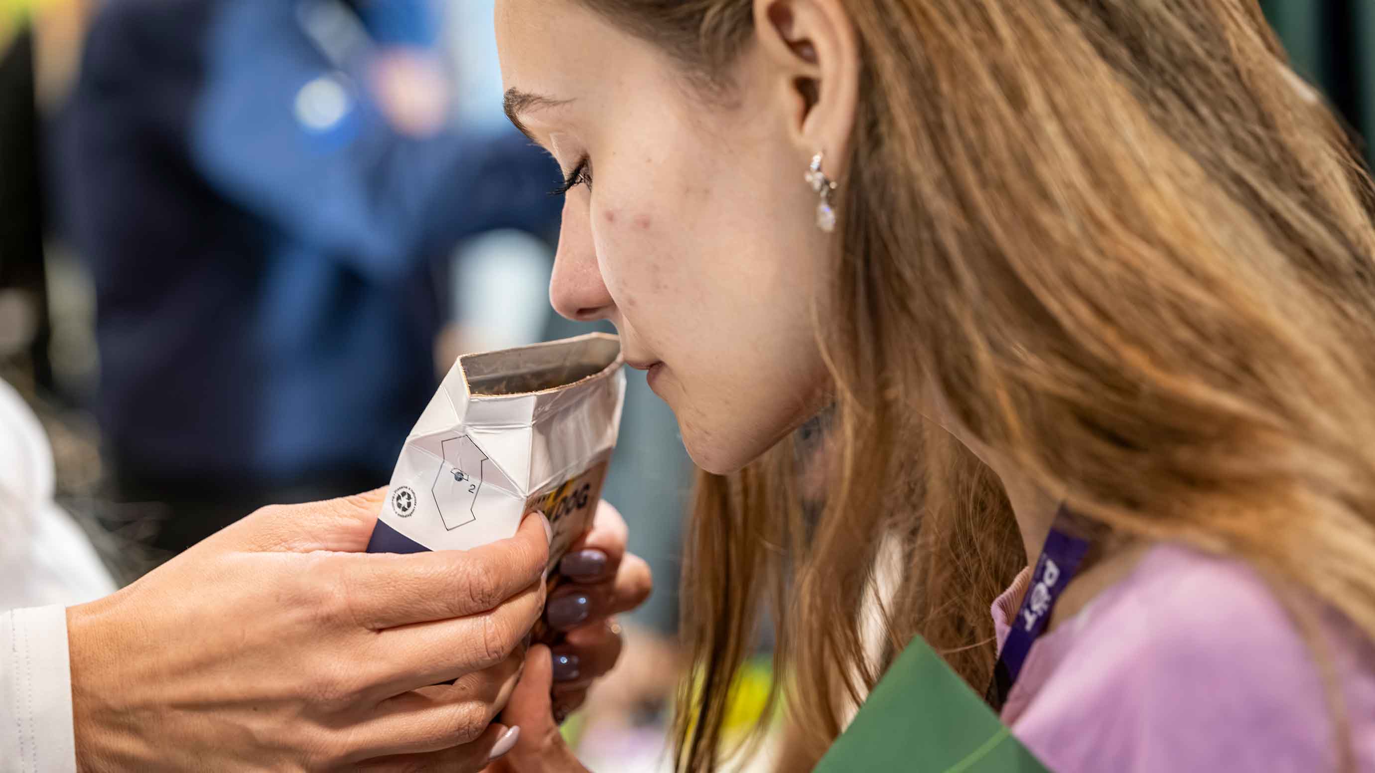 A visitor sniffs a product at PET South America